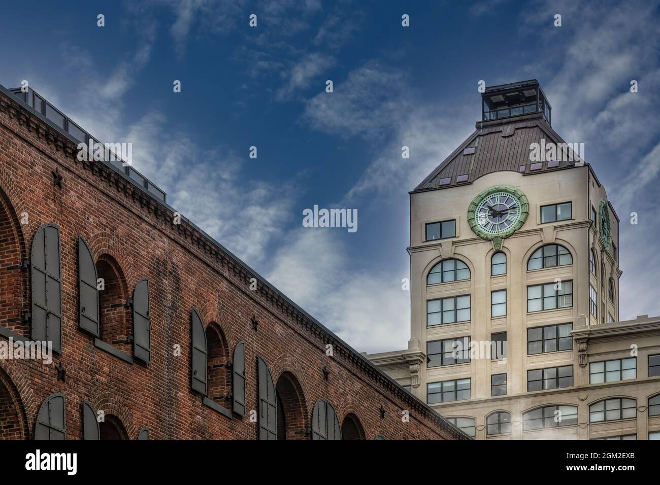 Dumbo's Clock Tower - View leading from St. Ann’s Warehouse Theatre to the Old Tower Clock building in the prominent neighborhood of DUMBO (Down Under Stock Photo