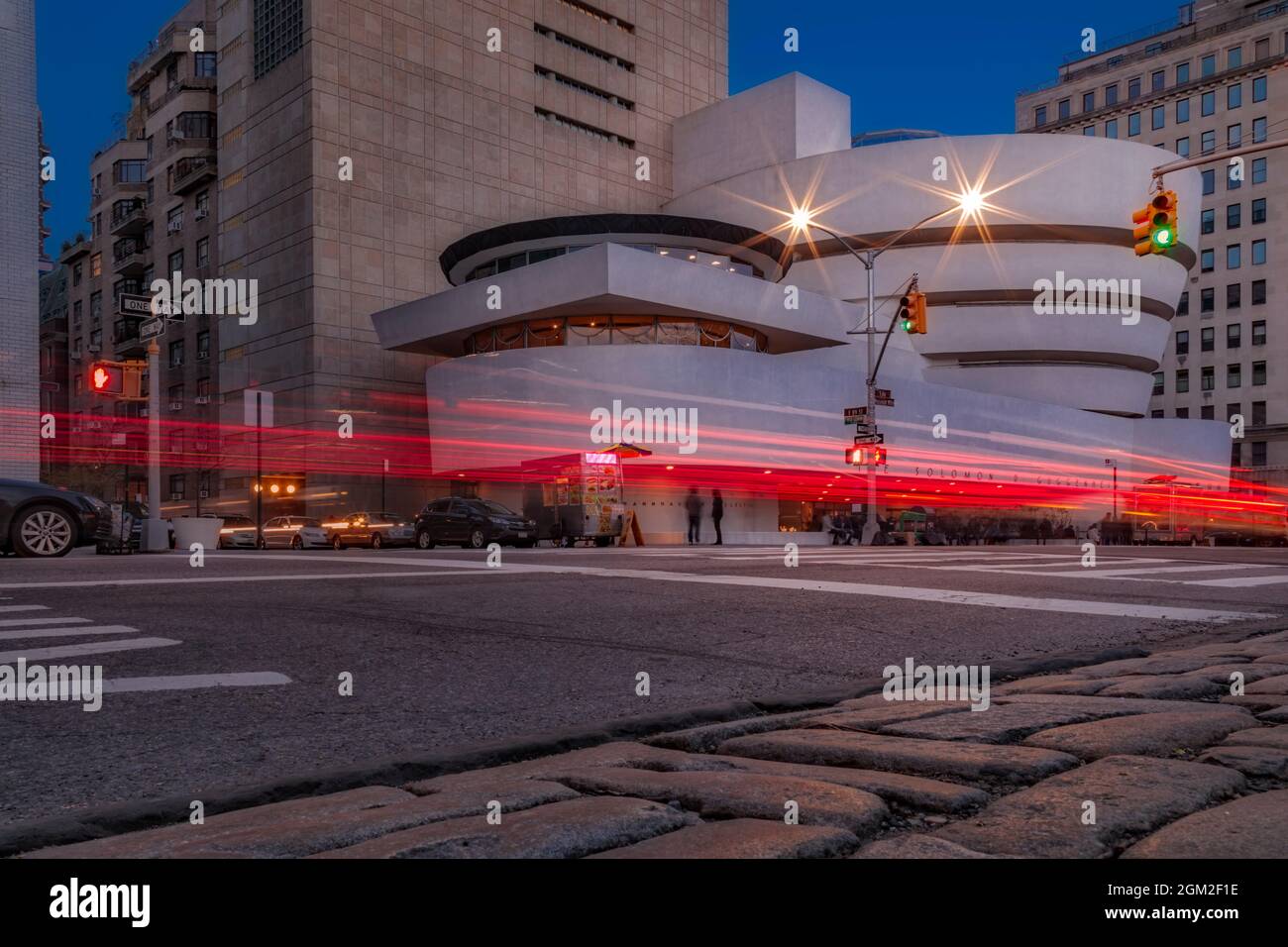 Guggenheim Museum NYC Light Streaks - View during twilight of the Solomon R. Guggenheim Museum and light trails on 89th Street and Fifth Avenue on the Stock Photo