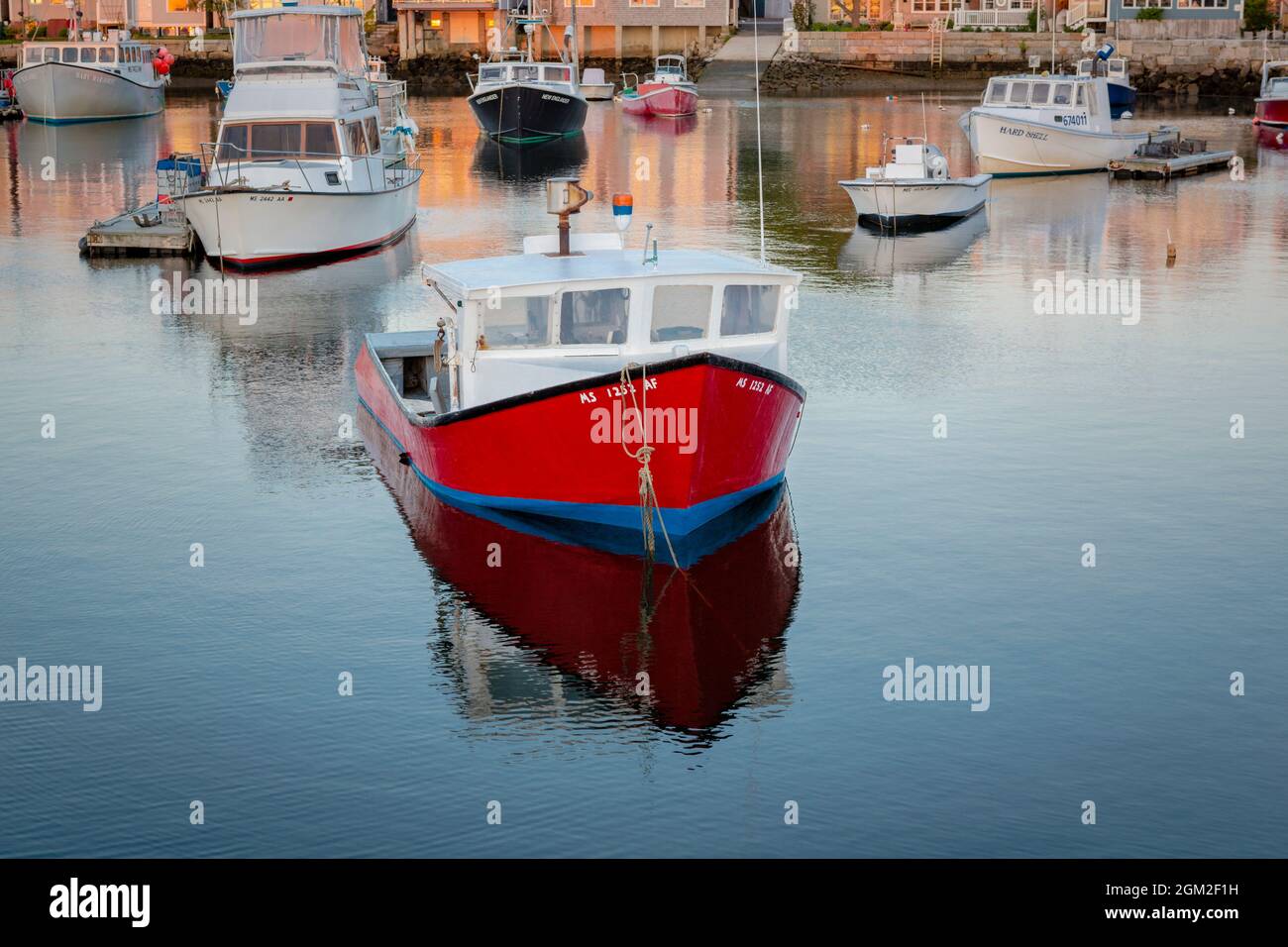 Colorful fishing and pleasure boats docked at Bradley Wharf during sunrise in Rockport, Massachusetts. Stock Photo