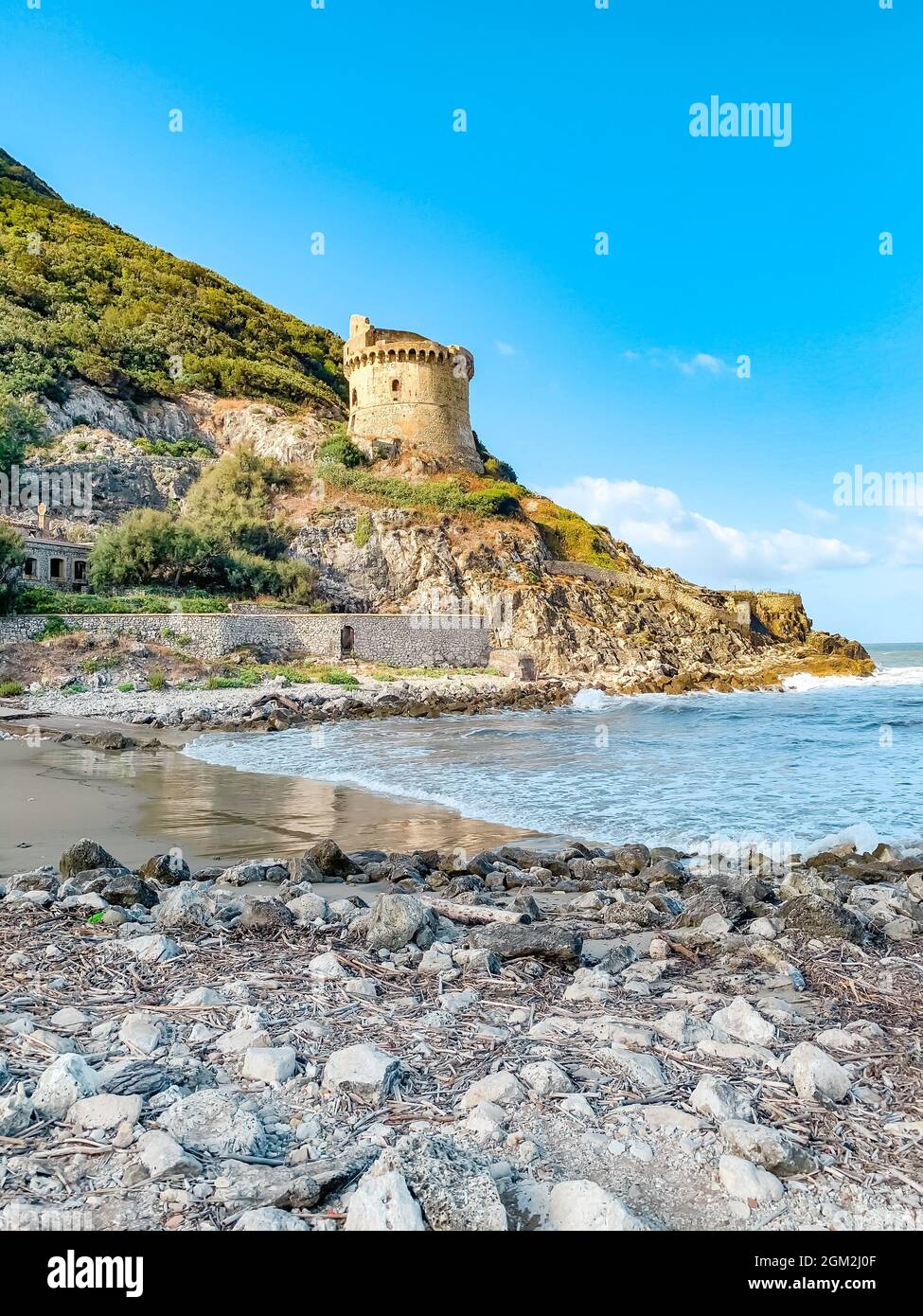 Ancient roman defense tower Torre Paola on a hill near the Mediterranean Sea in the Circeo National Park. Beautiful coast of Lungomare di Sabaudia Stock Photo