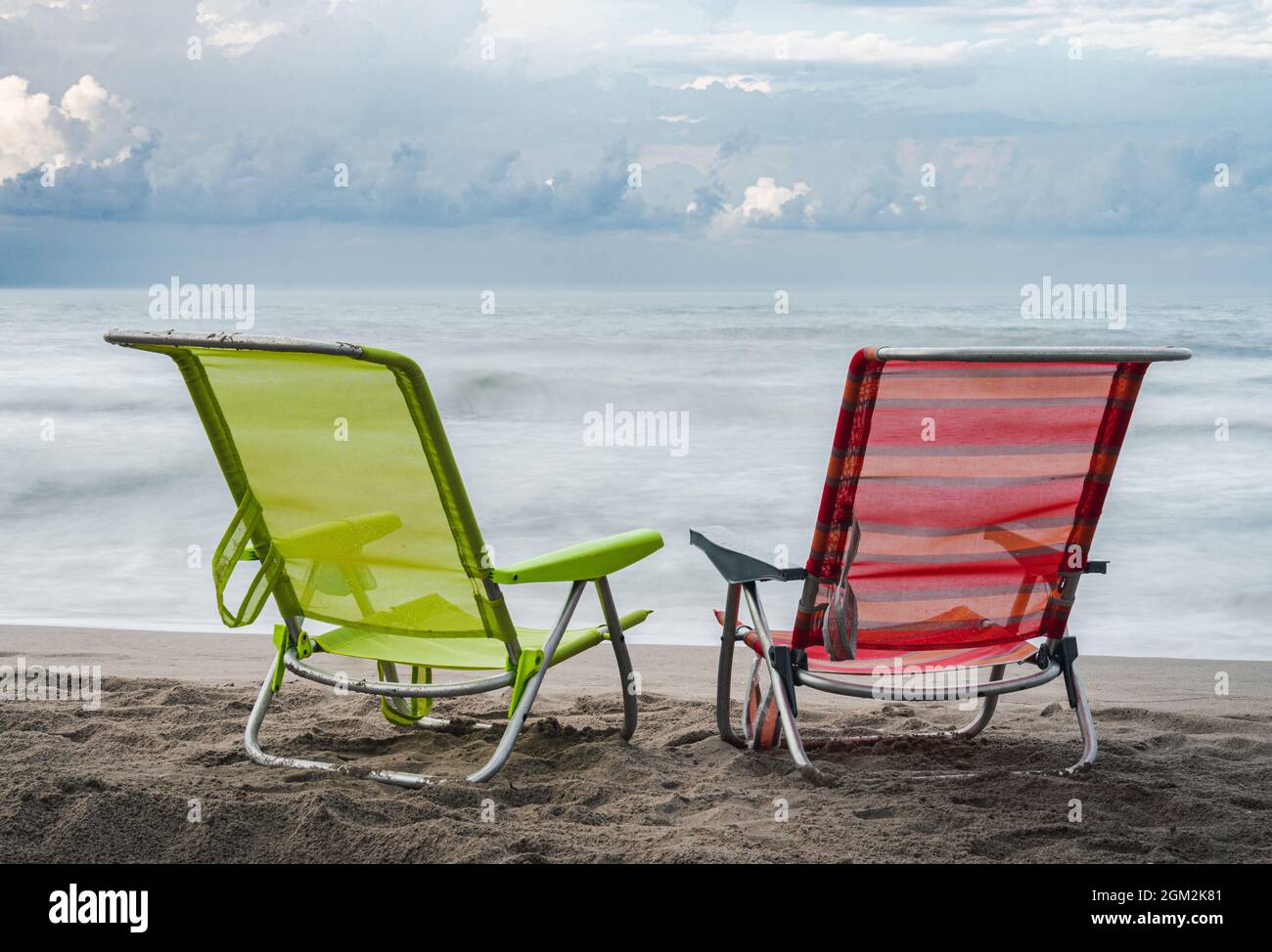 Folding chairs at a sand beach Stock Photo