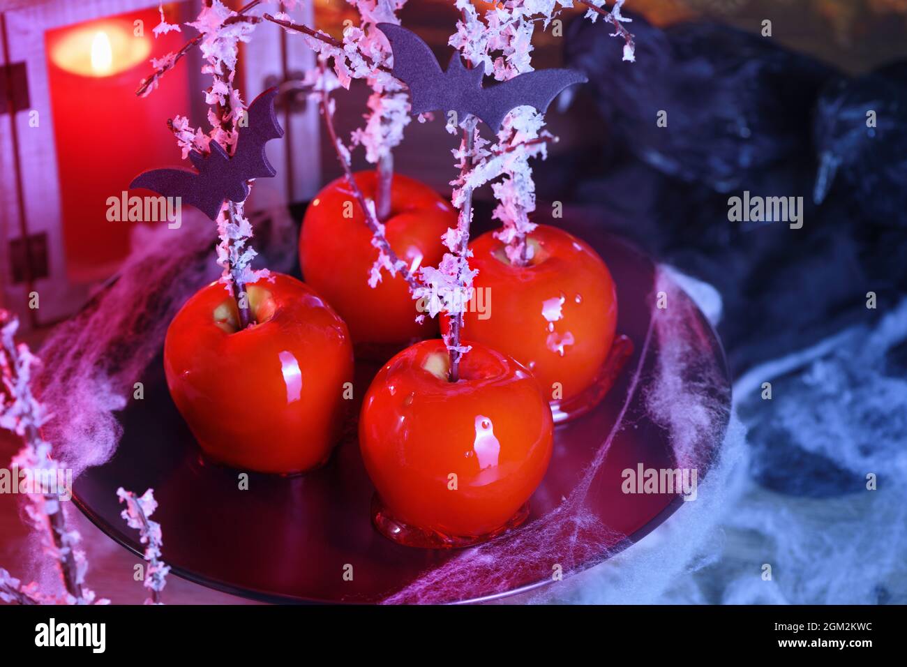 Halloween dessert. Poisoned blood caramelized glazed candy apple. Snow White Poison Lollipops. Stock Photo