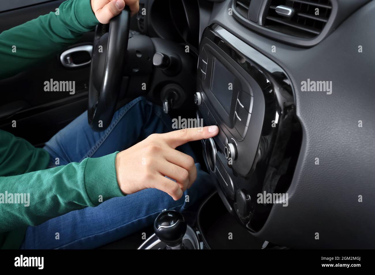 Man tuning radio in car Stock Photo Alamy