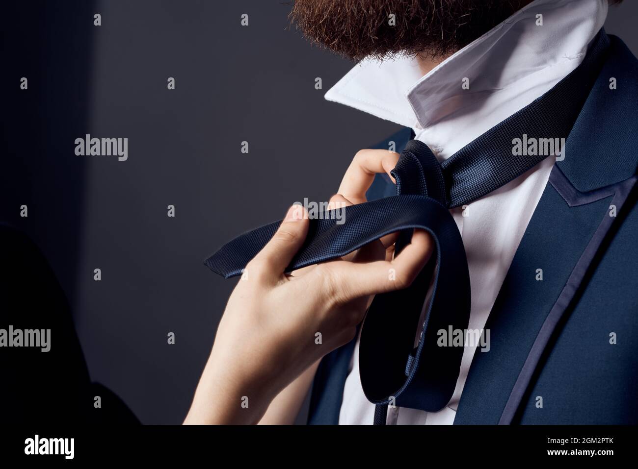 Image showcasing bearded man in suit tying tie elegant style Stock Photo - Alamy