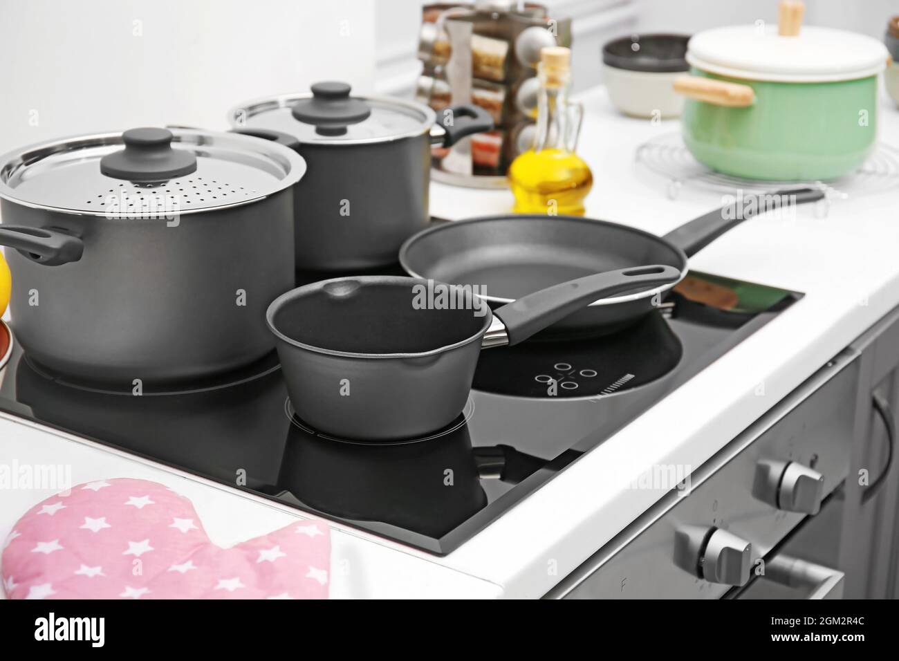 Cooking utensils on electric stove in kitchen Stock Photo - Alamy