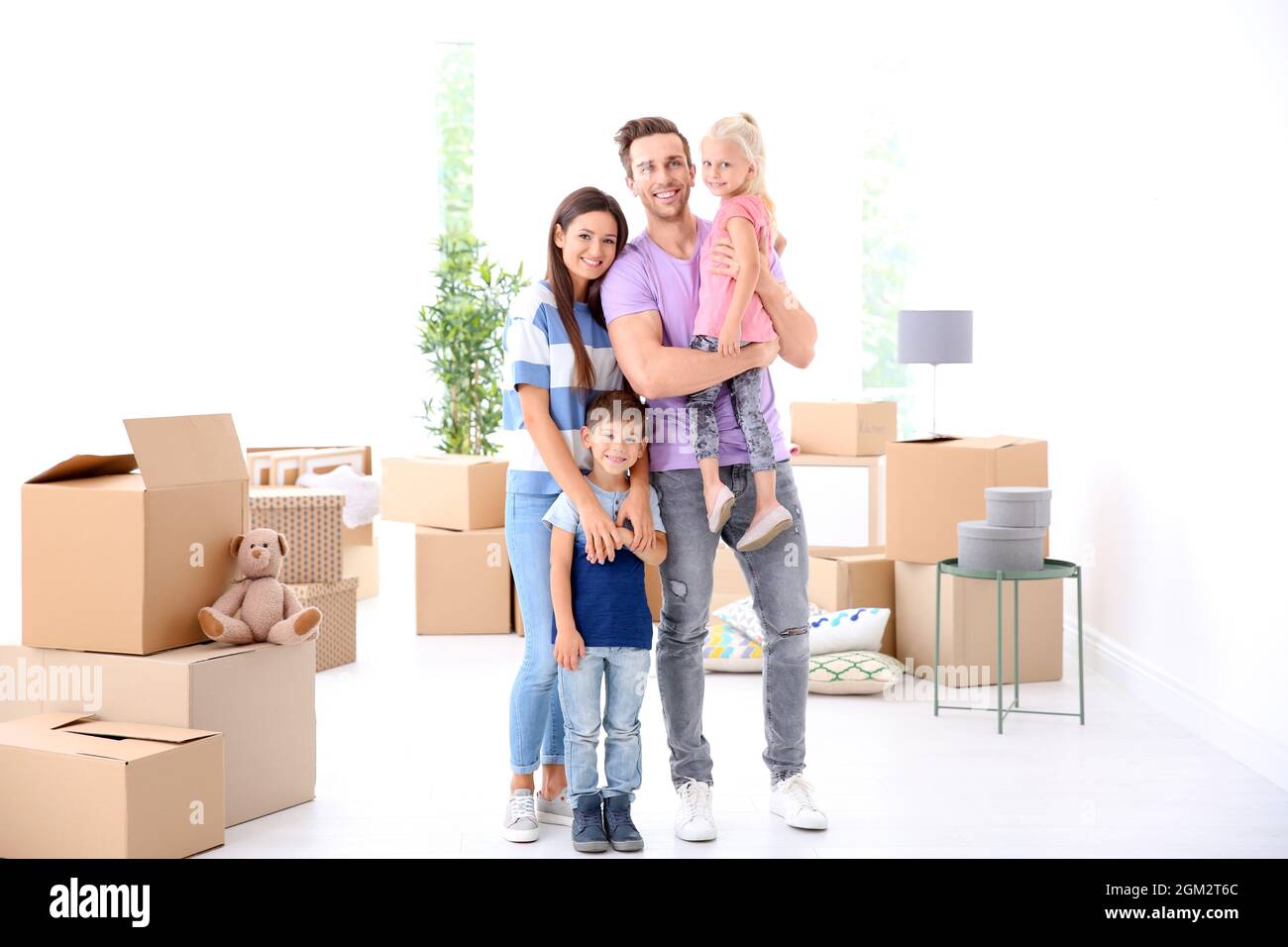 Happy family in their new home Stock Photo - Alamy