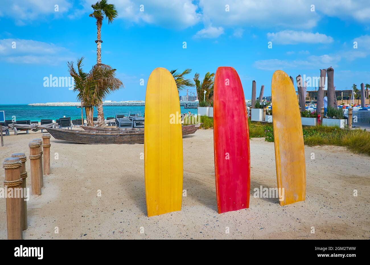 The colorful surfboards decorate the sand La Mer public beach, Dubai