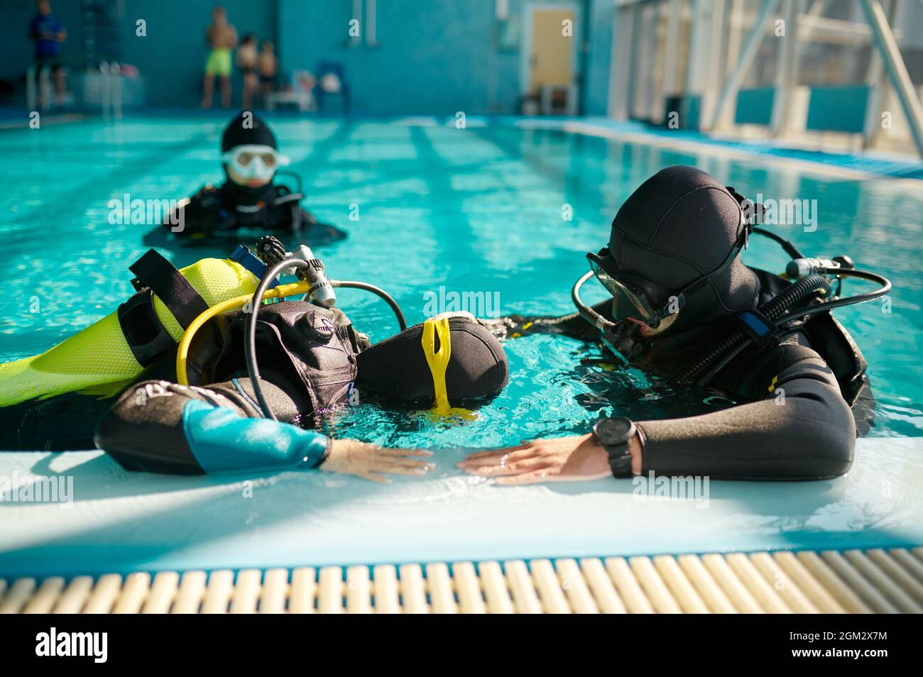 Instructor and divers in aqualungs, diving school Stock Photo
