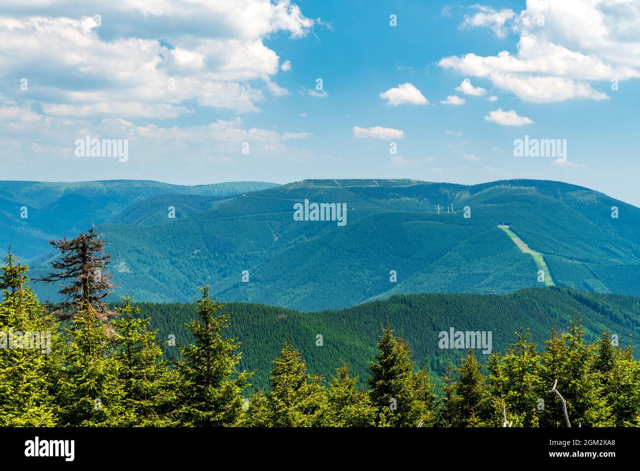 View to Dlouhe strane from Spaleny vrch hill in Jeseniky mountains in Czech republic during beautiful day with blue sky and clouds Stock Photo