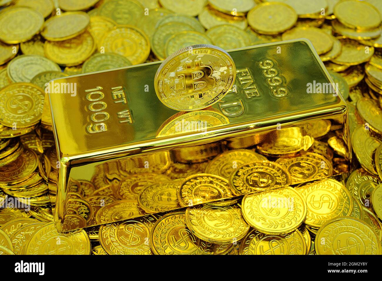 Bitcoin cryptocurrency on the gold bar and pile gold coin Stock Photo -  Alamy