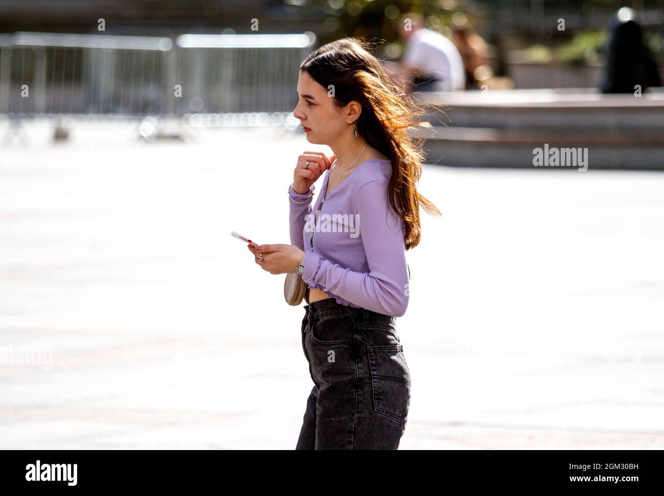 Dundee, Tayside, Scotland, UK. 16th Sep, 2021. UK weather: Warm mid September sunshine across North East Scotland with temperatures reaching 19°C. A young woman spending the day out enjoying the glorious warm sunny weather whilst talking on her mobile phone in Dundee city centre. Credit: Dundee Photographics/Alamy Live News Stock Photo