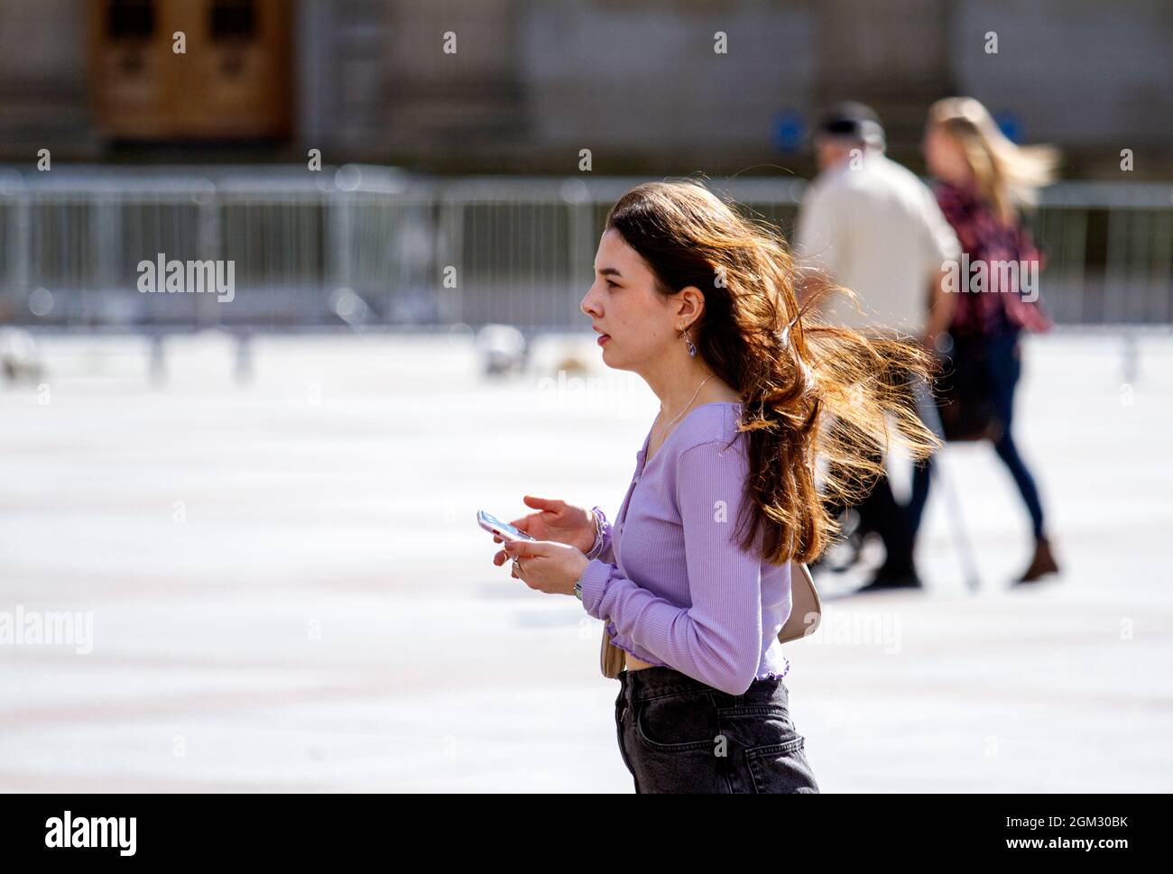 Dundee, Tayside, Scotland, UK. 16th Sep, 2021. UK weather: Warm mid September sunshine across North East Scotland with temperatures reaching 19°C. A young woman spending the day out enjoying the glorious warm sunny weather whilst talking on her mobile phone in Dundee city centre. Credit: Dundee Photographics/Alamy Live News Stock Photo