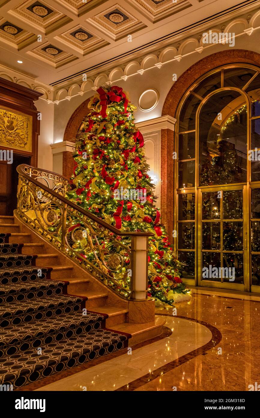 New York Palace Hotel - View to the luxury hotel lobby from the courtyard entrance decorated for Christmas during the holidays.   The courtyard was on Stock Photo