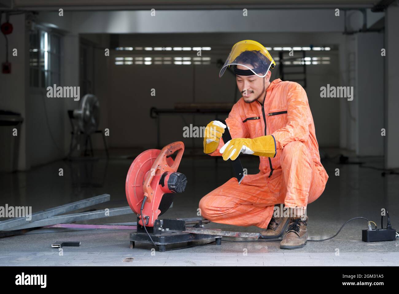 Industrial worker inspect cut steel to the size required by customer. For the real estate project received. Metal grinding on steel spare part in work Stock Photo