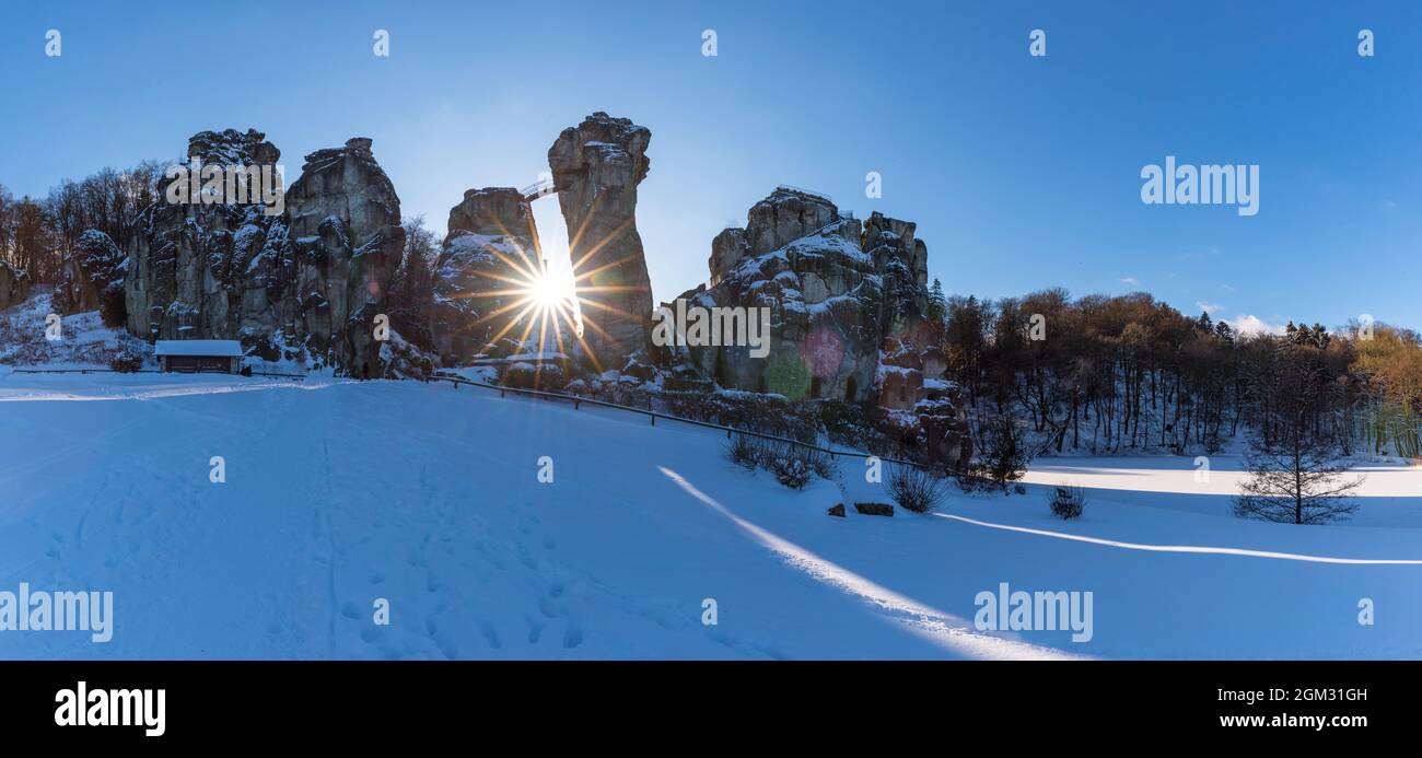 The famous Externsteine in the wonderful lght of the setting sun. A very mystical place you have to visit when you are in this area. Stock Photo