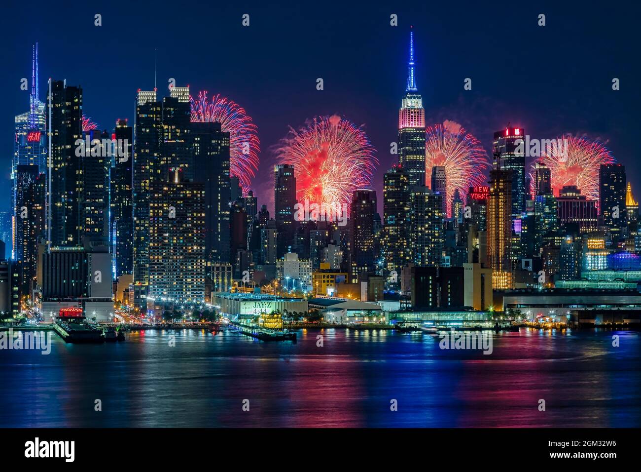 NYC Fireworks Celebration -  New York City skyline with the Macy's Spectacular 4th of July Fireworks Celebration Show as a backdrop to midtown Manhatt Stock Photo