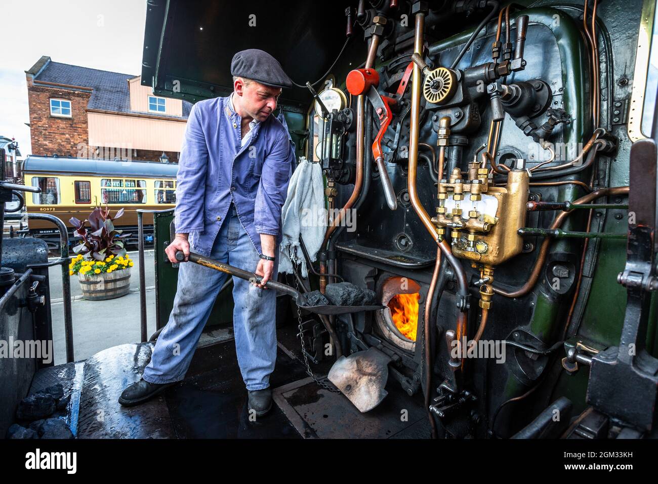 Kidderminster, Worcs, UK. 16th September, 2021. Engine driver Dave Ward tends the fire box of his steam loco at  the Severn Valley Railway station,  Kidderminster, on the opening day of the Severn Valley Railway's Autumn Steam Gala, Kidderminster, Worcestershire. SVR volunteer Dave Ward is normally to seen driving CrossCountry trains in his full-time job. The gala lasts until Sunday 19th September and features guest locos. Peter Lopeman/Alamy Live News Stock Photo