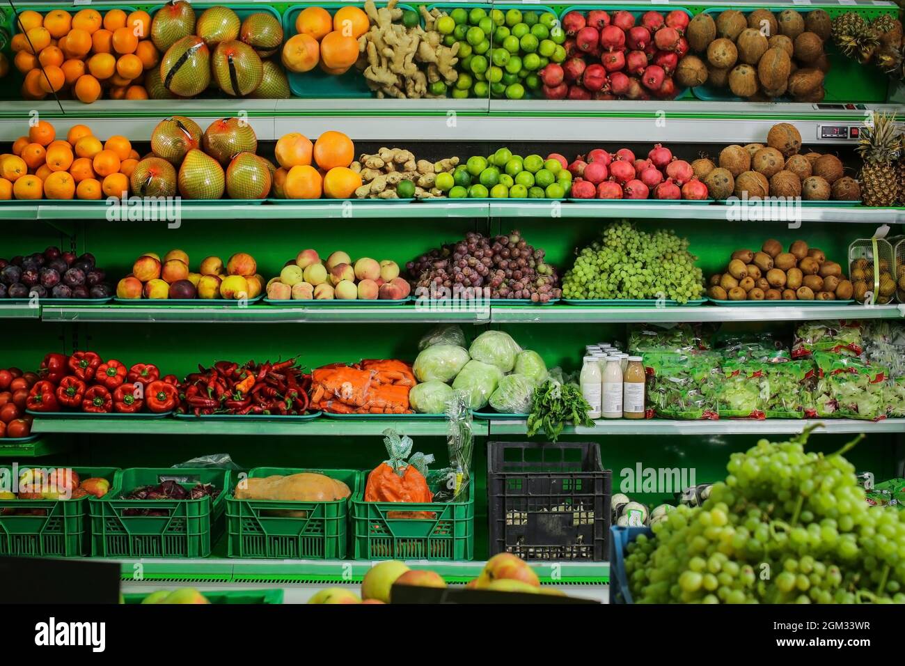Variety of different fruits and vegetables on shelves in supermarket