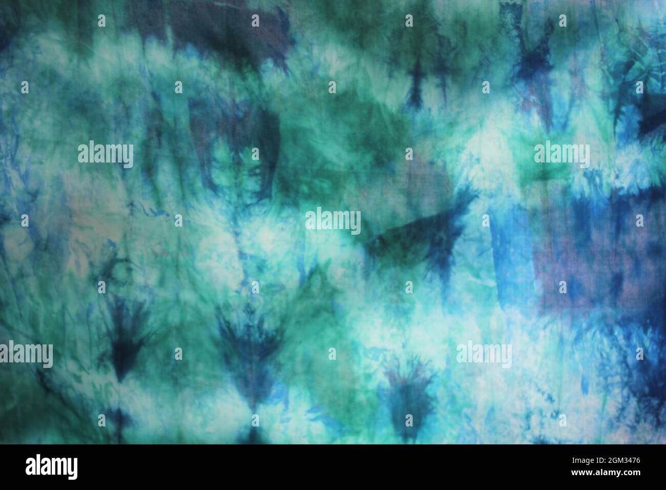 Tie dye green background with half circle layers of dye pattern fading