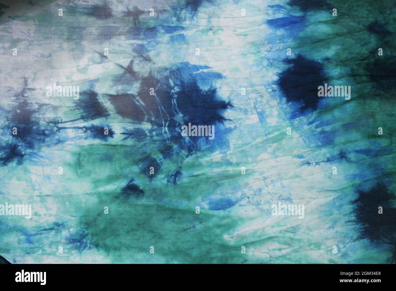 Tie dye green background with half circle layers of dye pattern fading