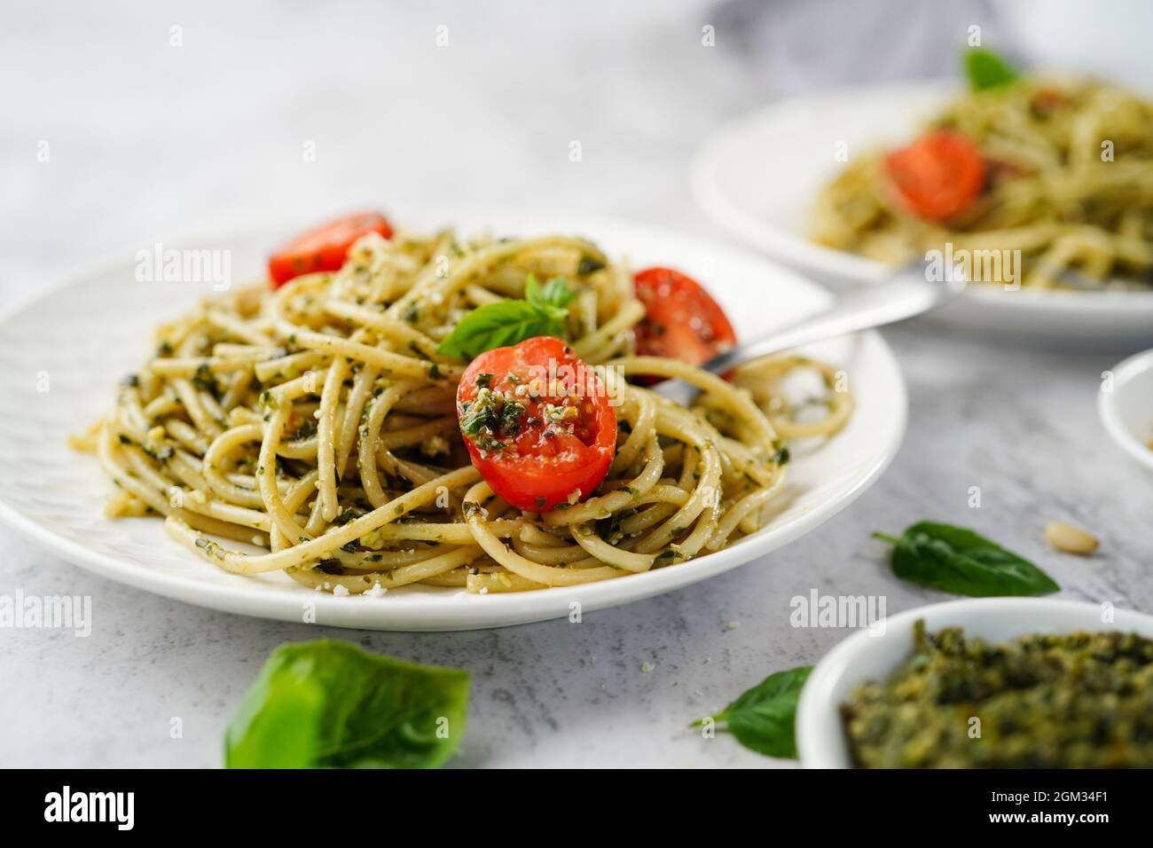 Homemade Pesto pasta with spaghetti cherry tomatoes and parmesan cheese