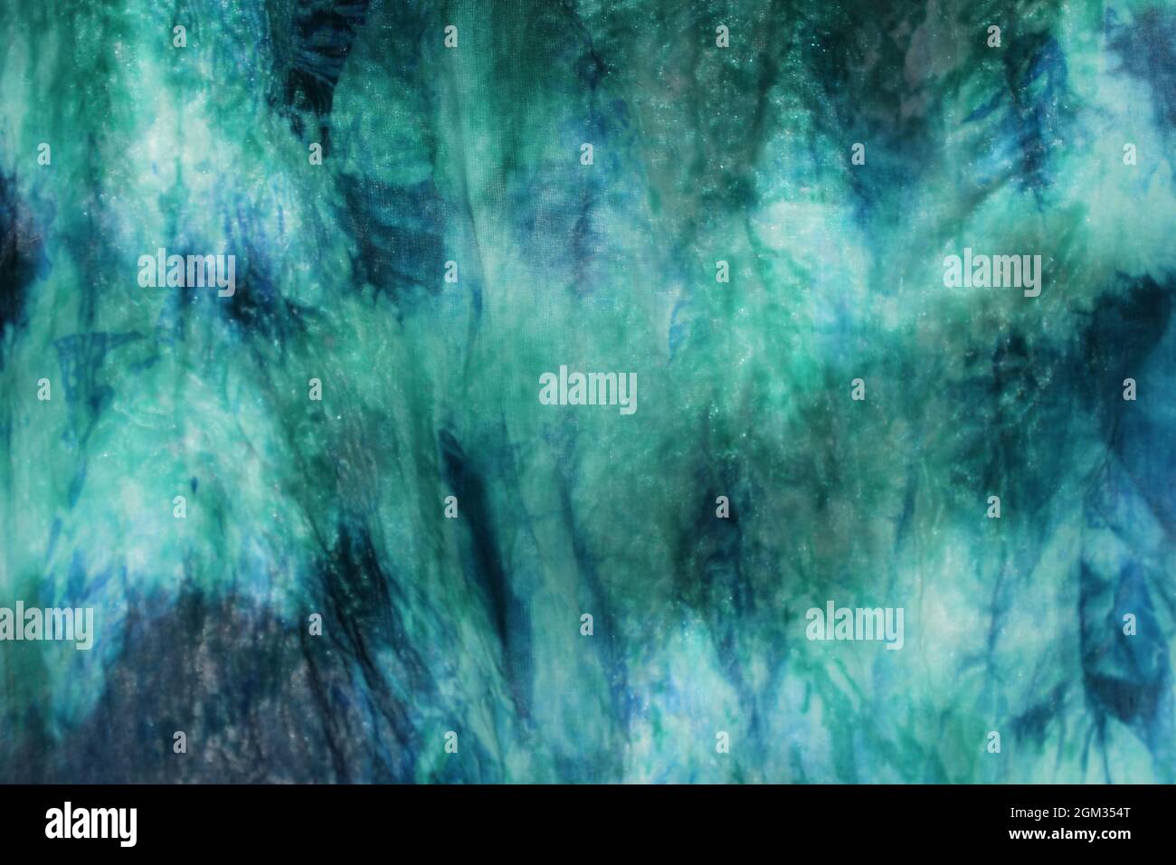 Tie dye green background with half circle layers of dye pattern fading