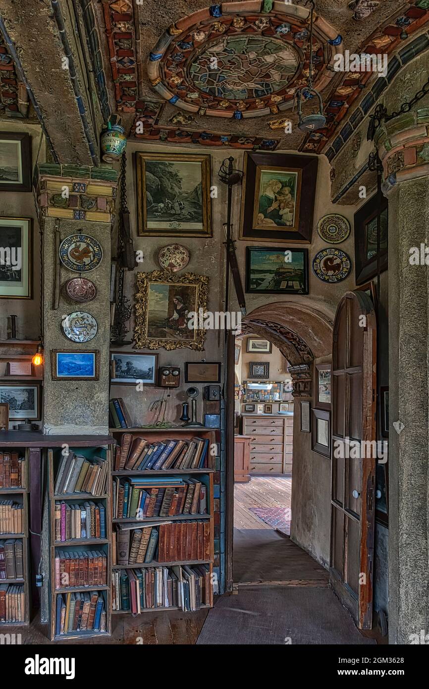 Fonthill Castle Interior - A view to an old stool, eclectic decor, many books and a desk located in the  Fonthill caslte study room which is adjacent Stock Photo