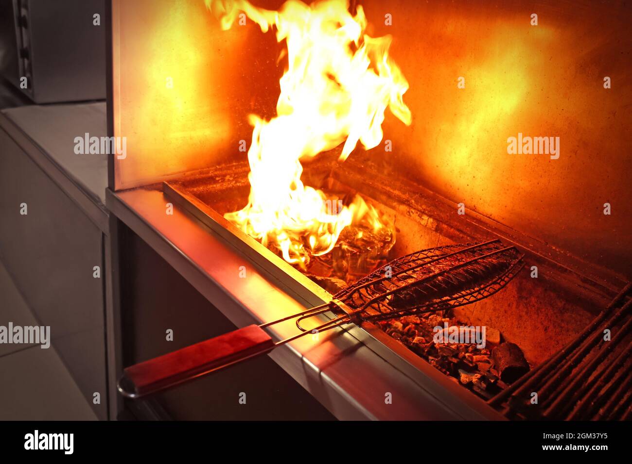 Cooking grilled fish in restaurant Stock Photo Alamy