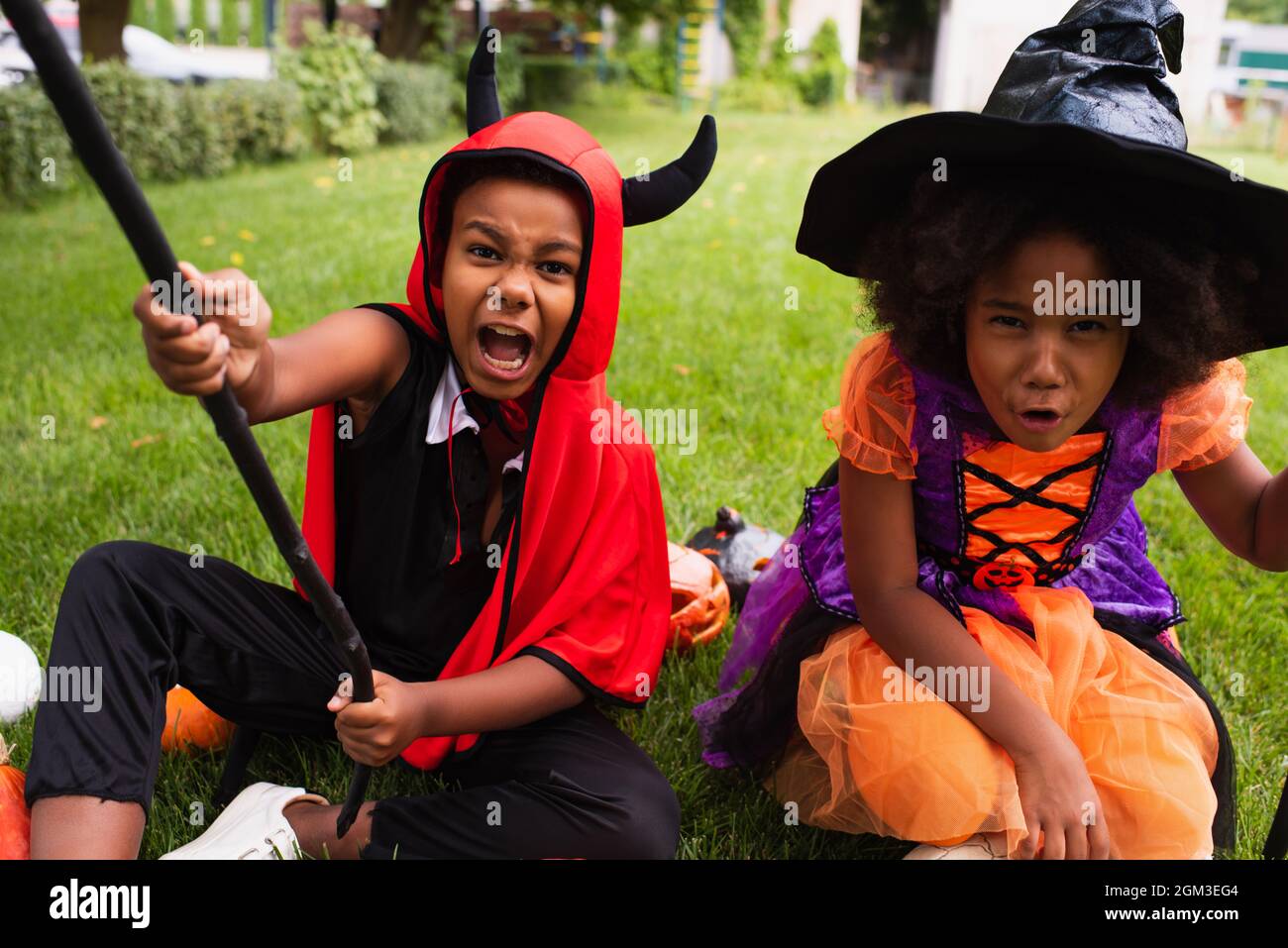 african american siblings in halloween costumes screaming while playing on  backyard Stock Photo - Alamy, image size:1300x957