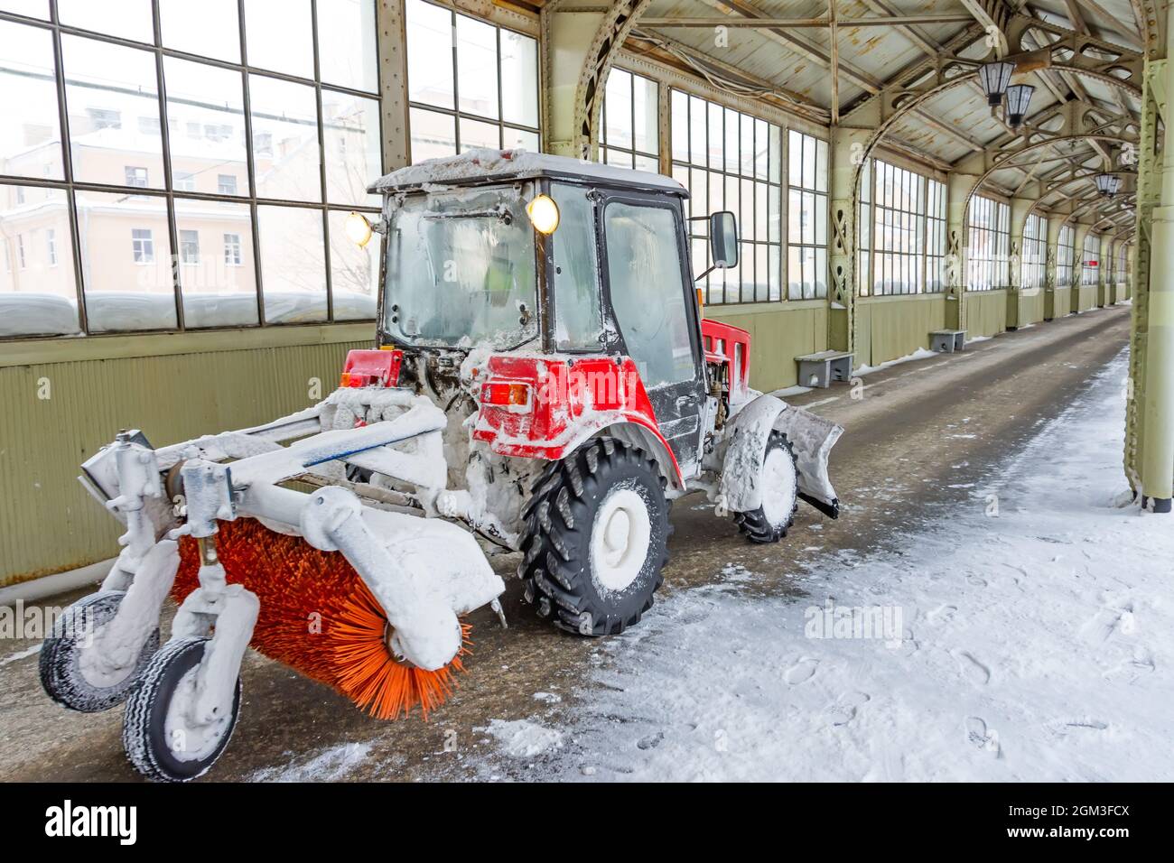 Tractor with rotating cleaning brush for sidewalks and walkways platform at the railway station Stock Photo