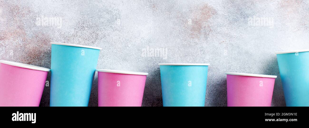 Pattern of pink and blue paper cup of coffee on old light background. Zero waste concept. Flat lay. Stock Photo