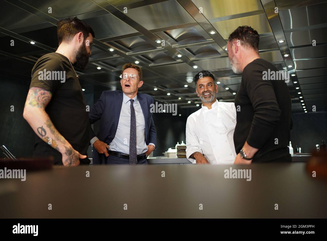 Mayor of the West Midlands, Andy Street talks to chefs Aktar Islam, Glynn Purnell (right) and Alex Claridge (left), at the Opheem restaurant, Birmingham, for the unveiling of a new working group of local employers and training providers who will tackle the jobs and skills issues facing the hospitality sector. Picture date: Thursday September 16, 2021. Stock Photo