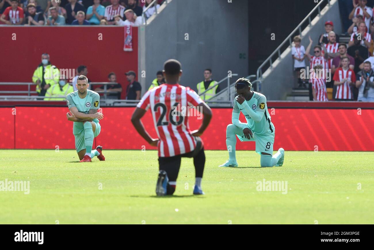 Players take the knee including Brighton's Yves Bissouma (r) during the Premier League match between Brentford and Brighton and Hove Albion  at the Brentford Community Stadium , London , UK - 11th September 2021 - Photo Simon Dack/Telephoto Images Editorial use only. No merchandising. For Football images FA and Premier League restrictions apply inc. no internet/mobile usage without FAPL license - for details contact Football Dataco Stock Photo