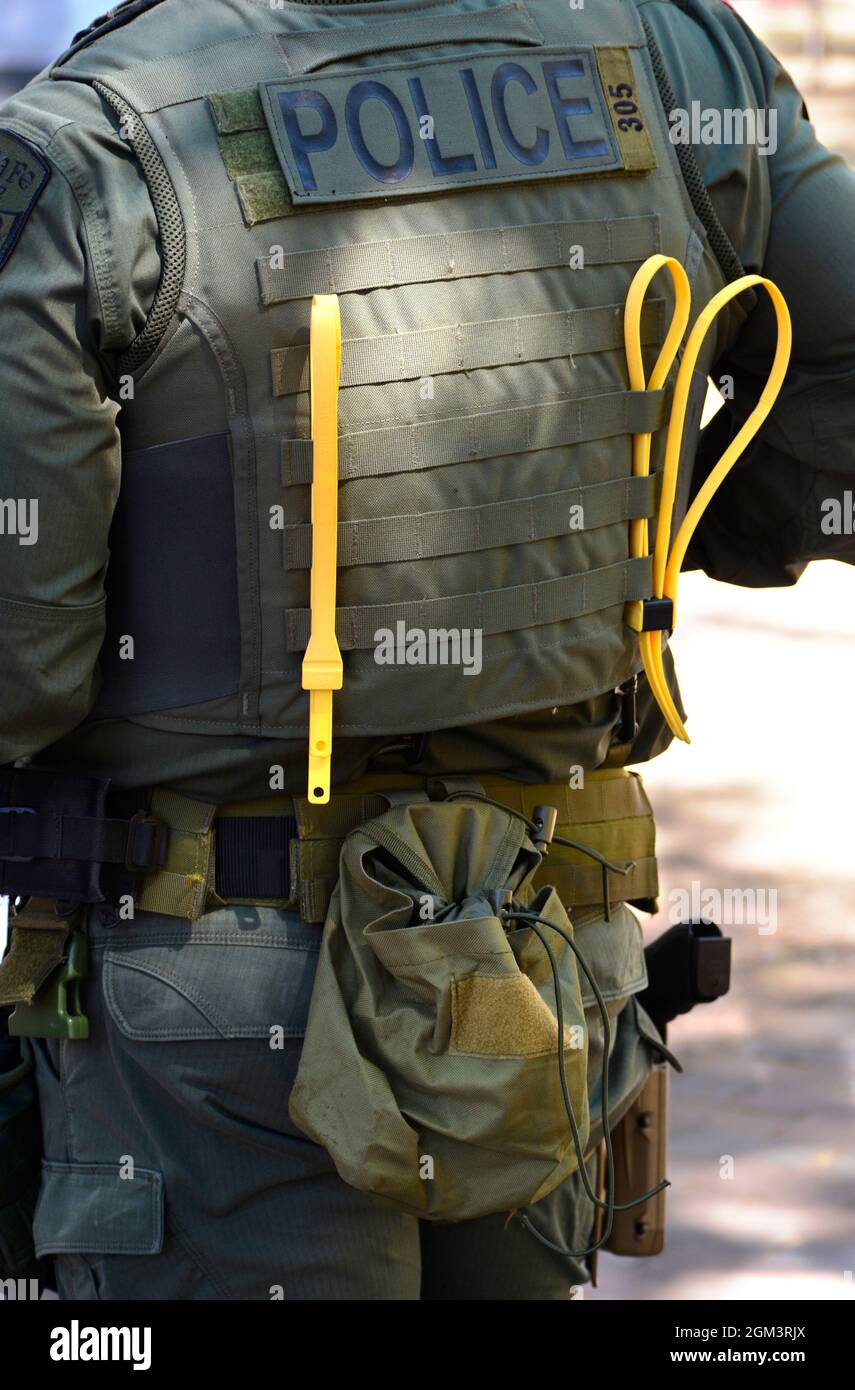 A members of the Santa Fe, New Mexico Police Department's SWAT team stands with plastic zip-tie handcuffs attached to his vest. Stock Photo