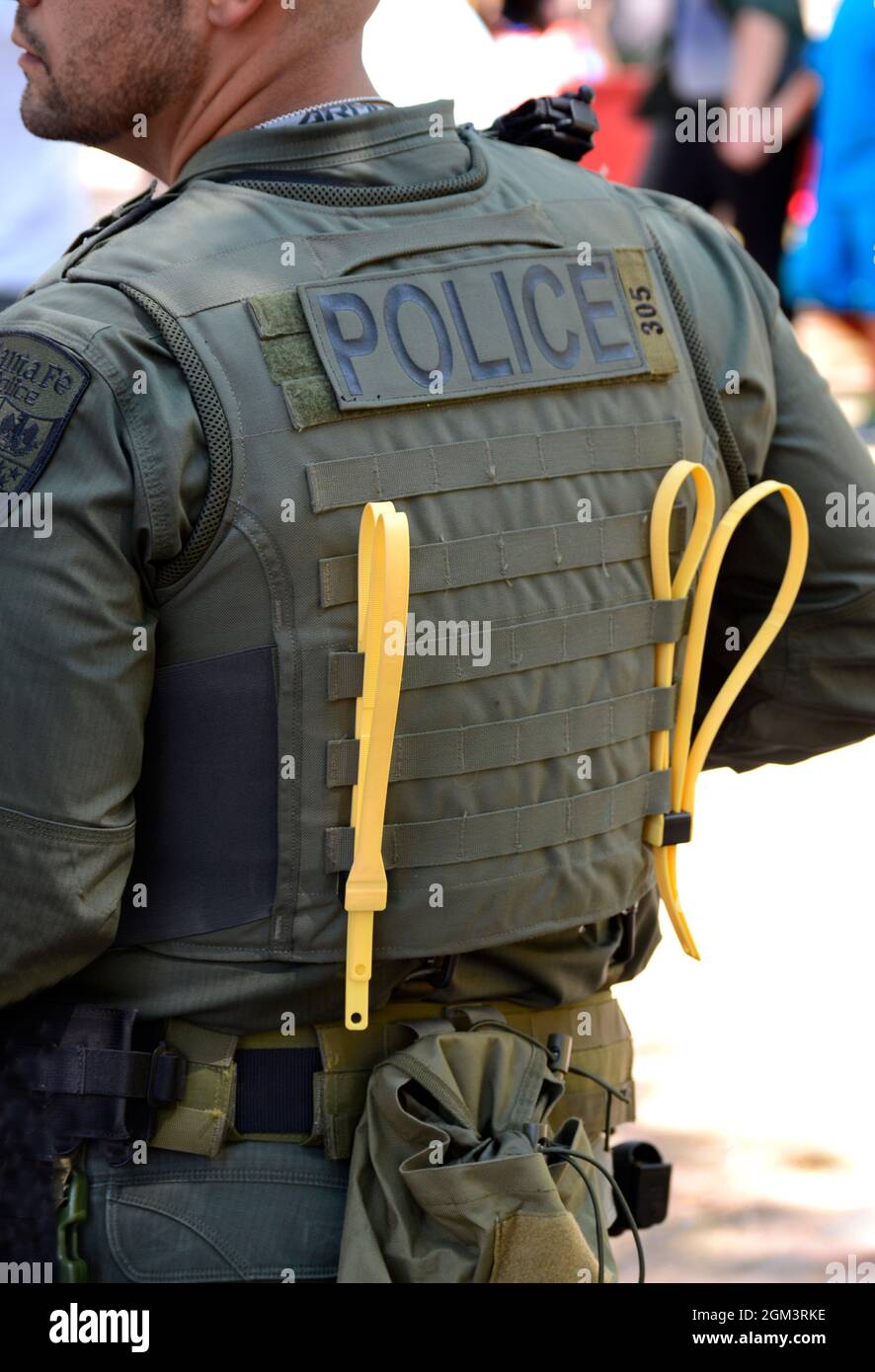 A members of the Santa Fe, New Mexico Police Department's SWAT team stands with plastic zip-tie handcuffs attached to his vest. Stock Photo
