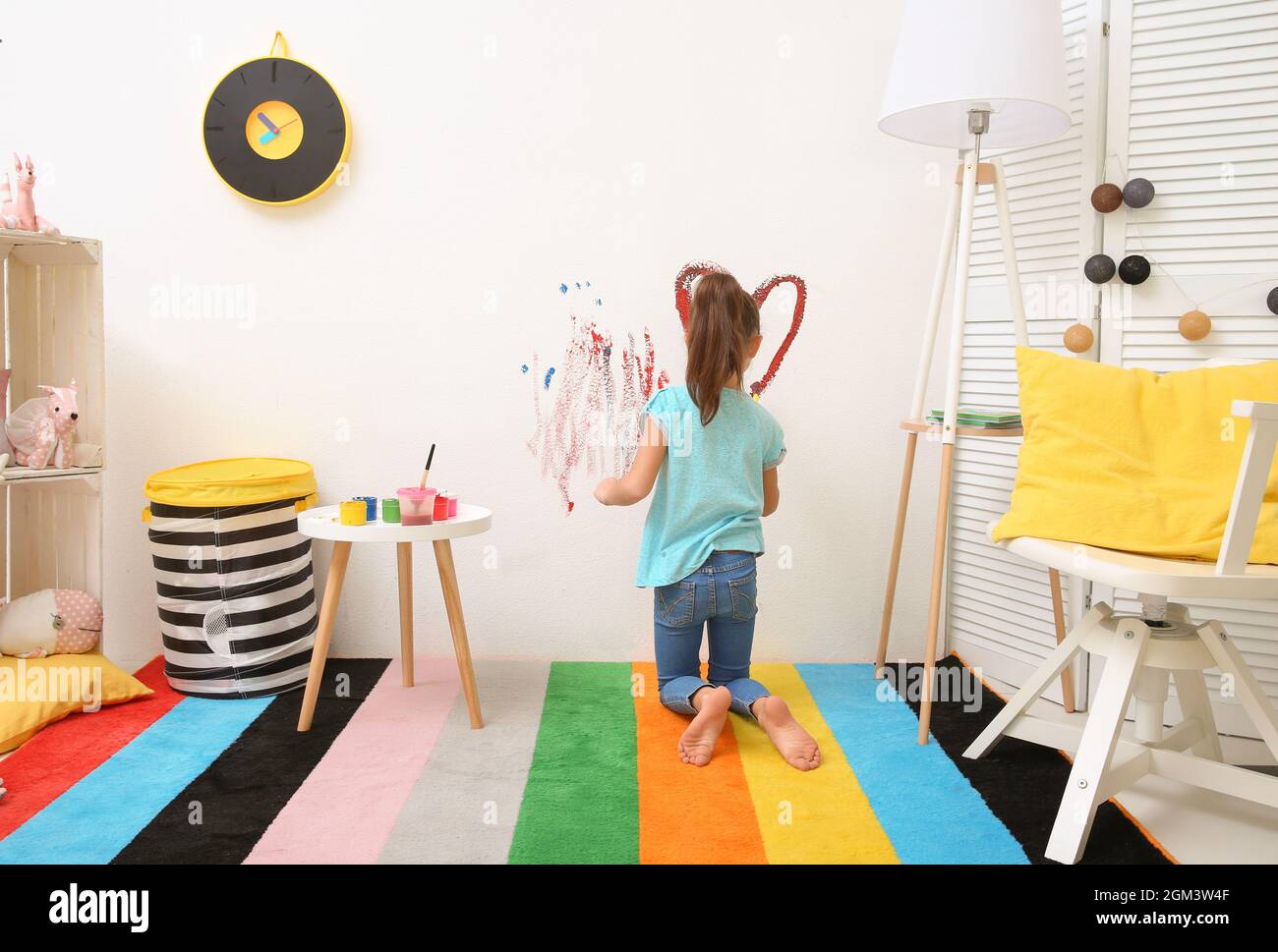 Little girl painting on wall at home Stock Photo Alamy
