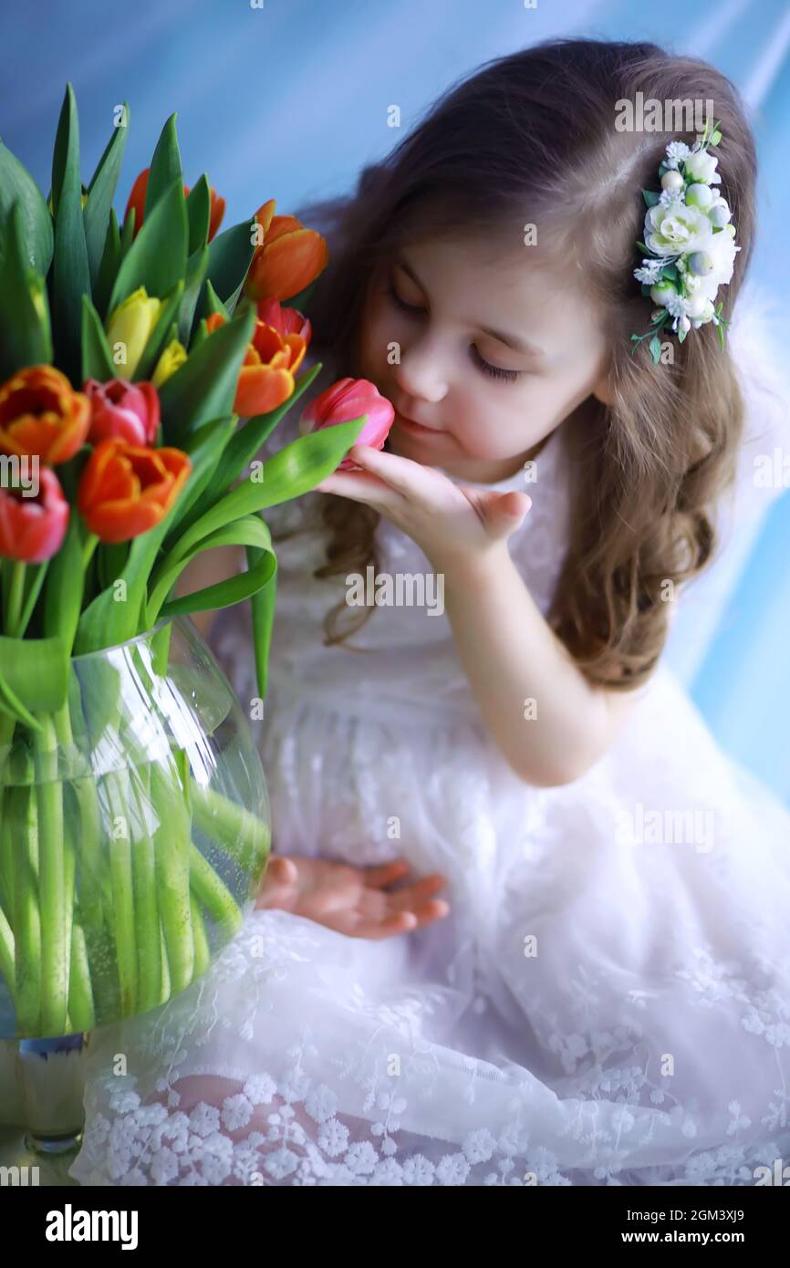 Beautiful girl in white dresses with a magnificent bouquet of first ...