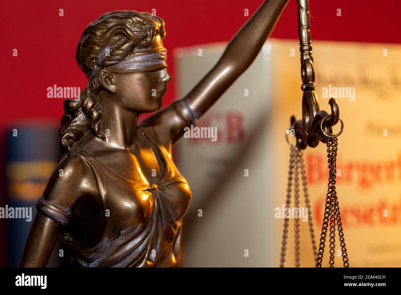 Symbol image of a court judgement Germany: Justitia with the German Civil Code in the background Stock Photo