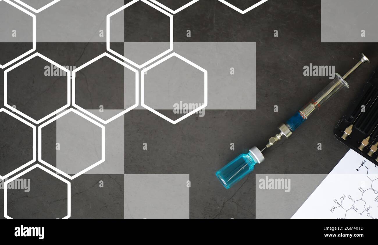 small jars with injection and syringe for injection on blue background ...