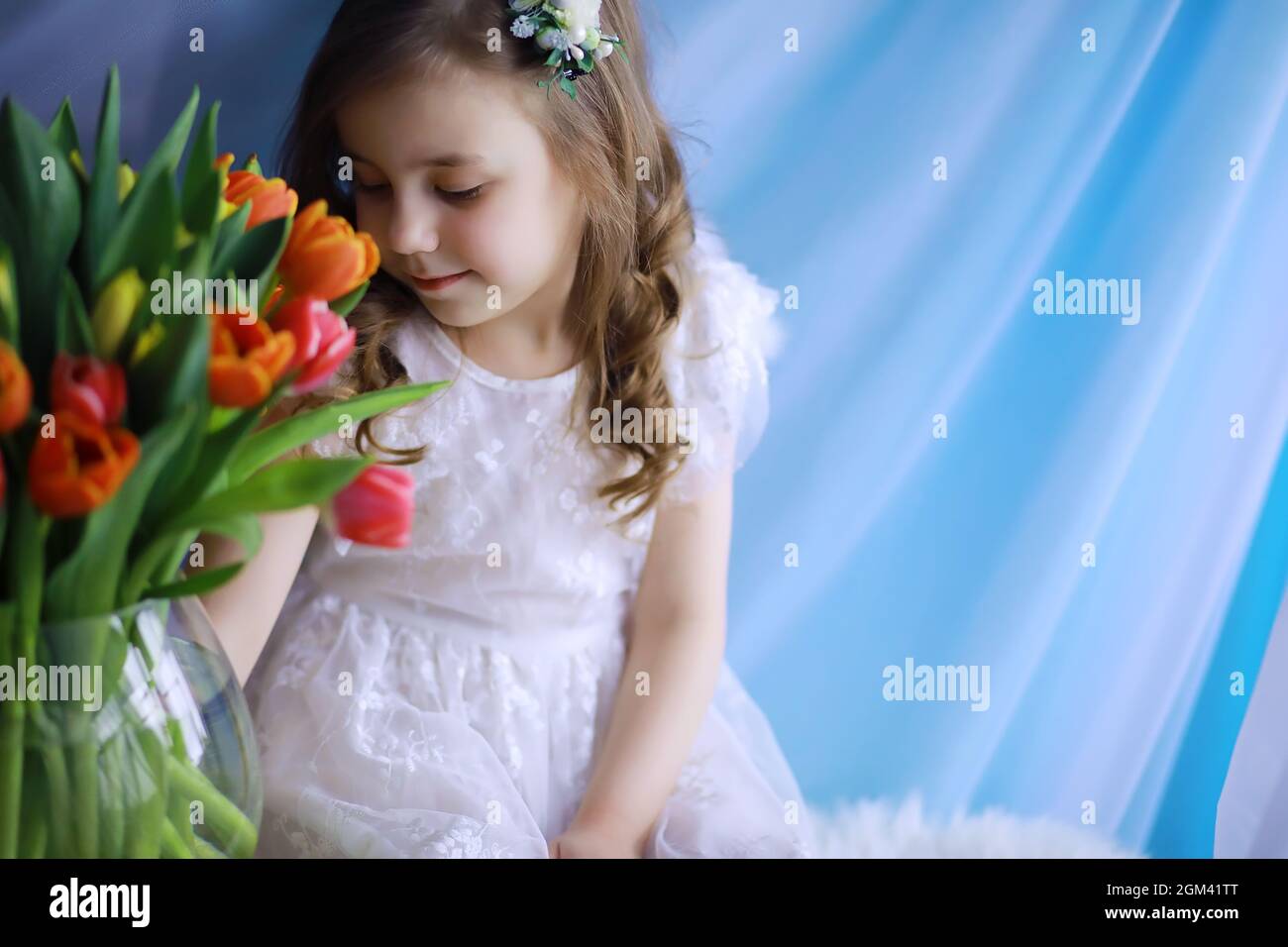 Beautiful girl in white dresses with a magnificent bouquet of first ...