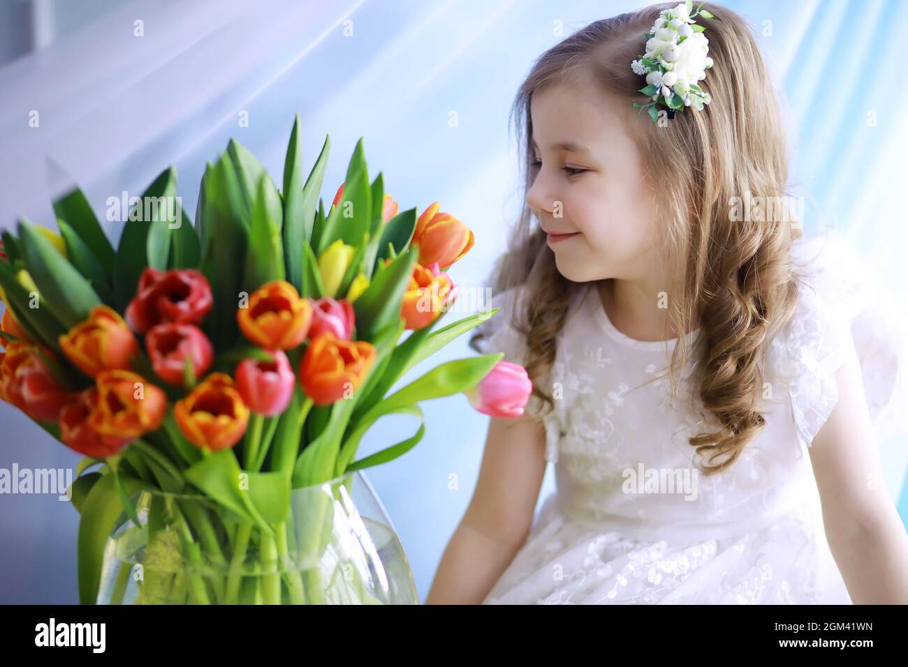 Beautiful girl in white dresses with a magnificent bouquet of first ...