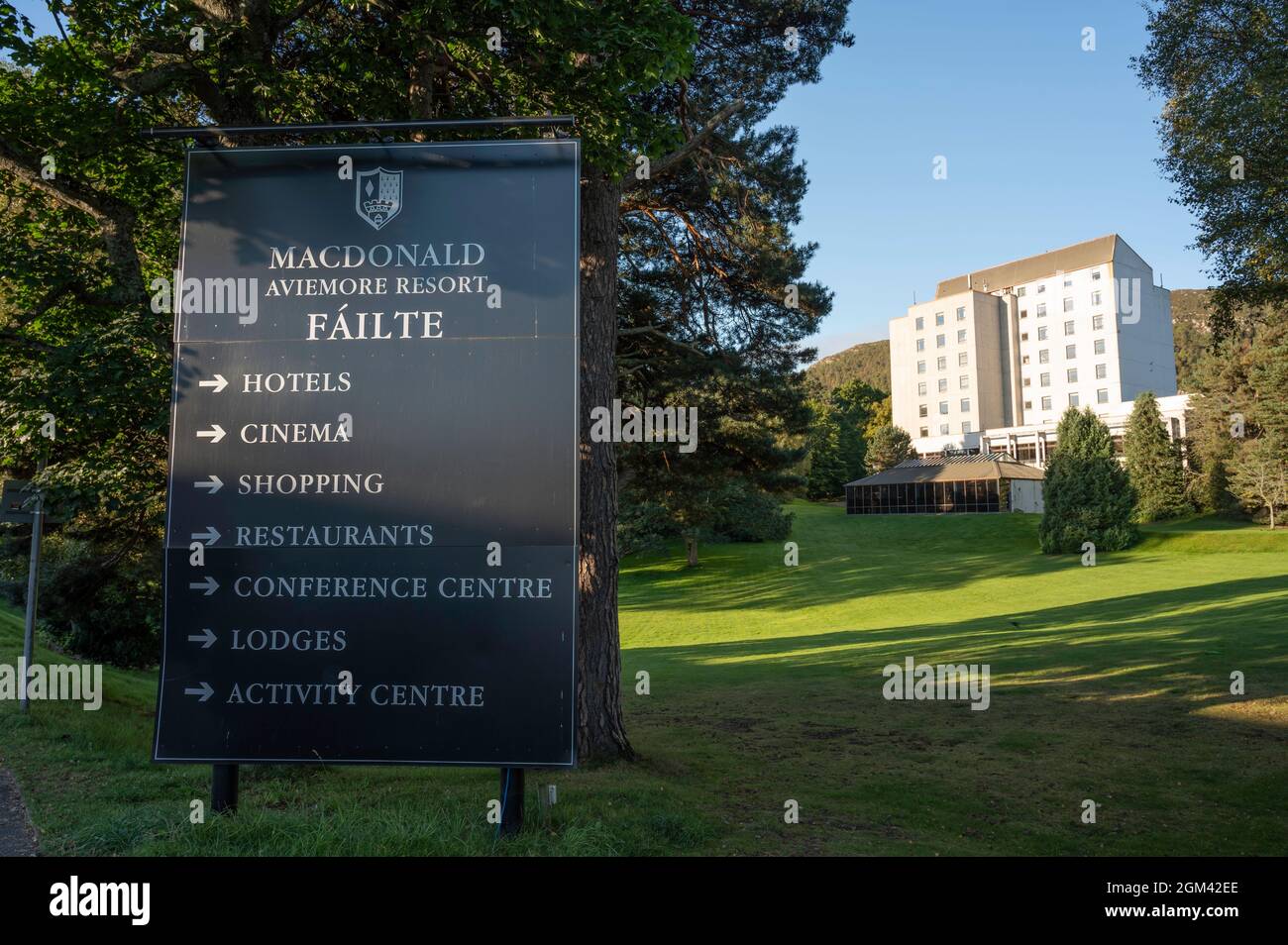 Sign for MacDonald Aviemore Resort with lawn and building of resort in background. Sunny day with blue sky. No people. Stock Photo