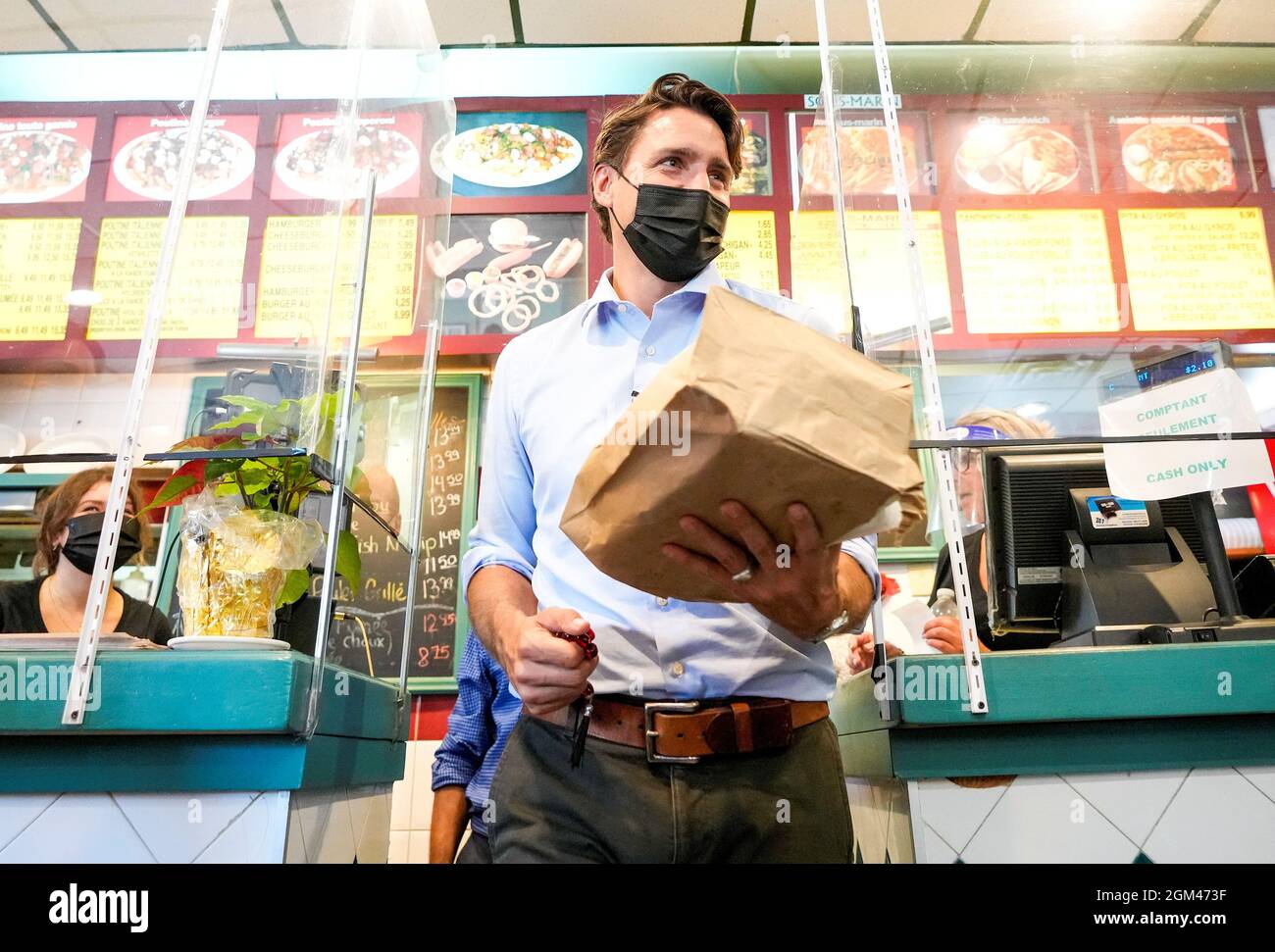 Canada's Liberal Prime Minister Justin Trudeau buys food at an election campaign stop in Blainville, Quebec, Canada September 16, 2021. REUTERS/Carlos Osorio Stock Photo
