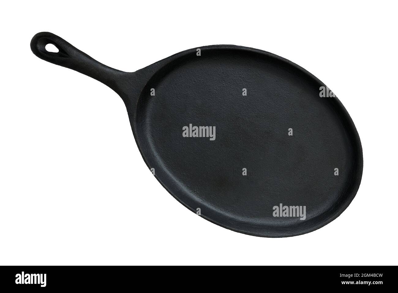 Oval cast iron pan for frying and serving dishes isolated on white