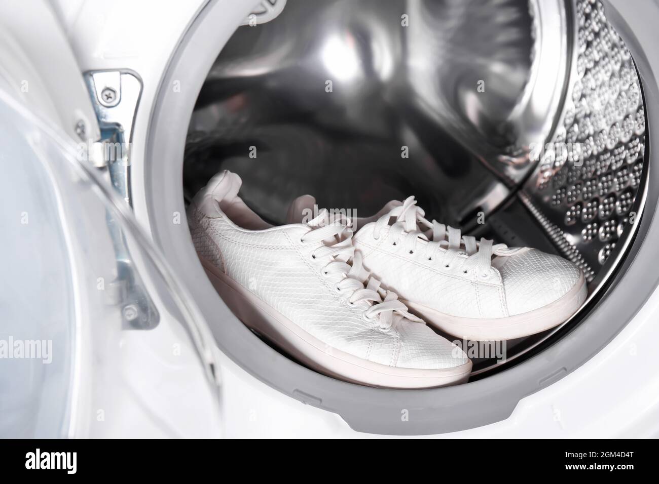 Pair of white sneakers in washing machine, closeup Stock Photo Alamy