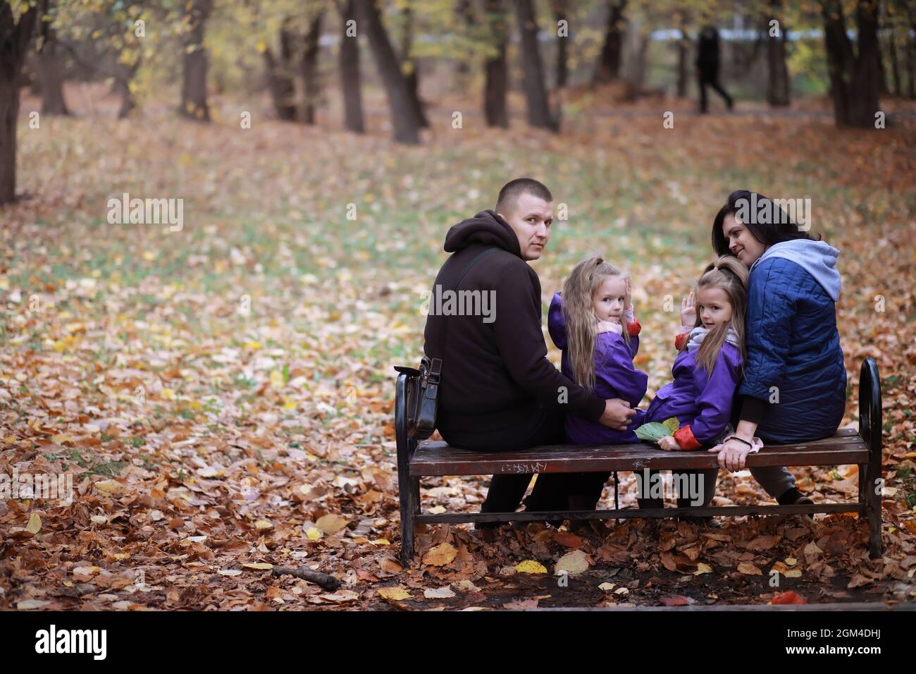 Young family on a walk in the autumn park on sunny day. Happiness to be ...
