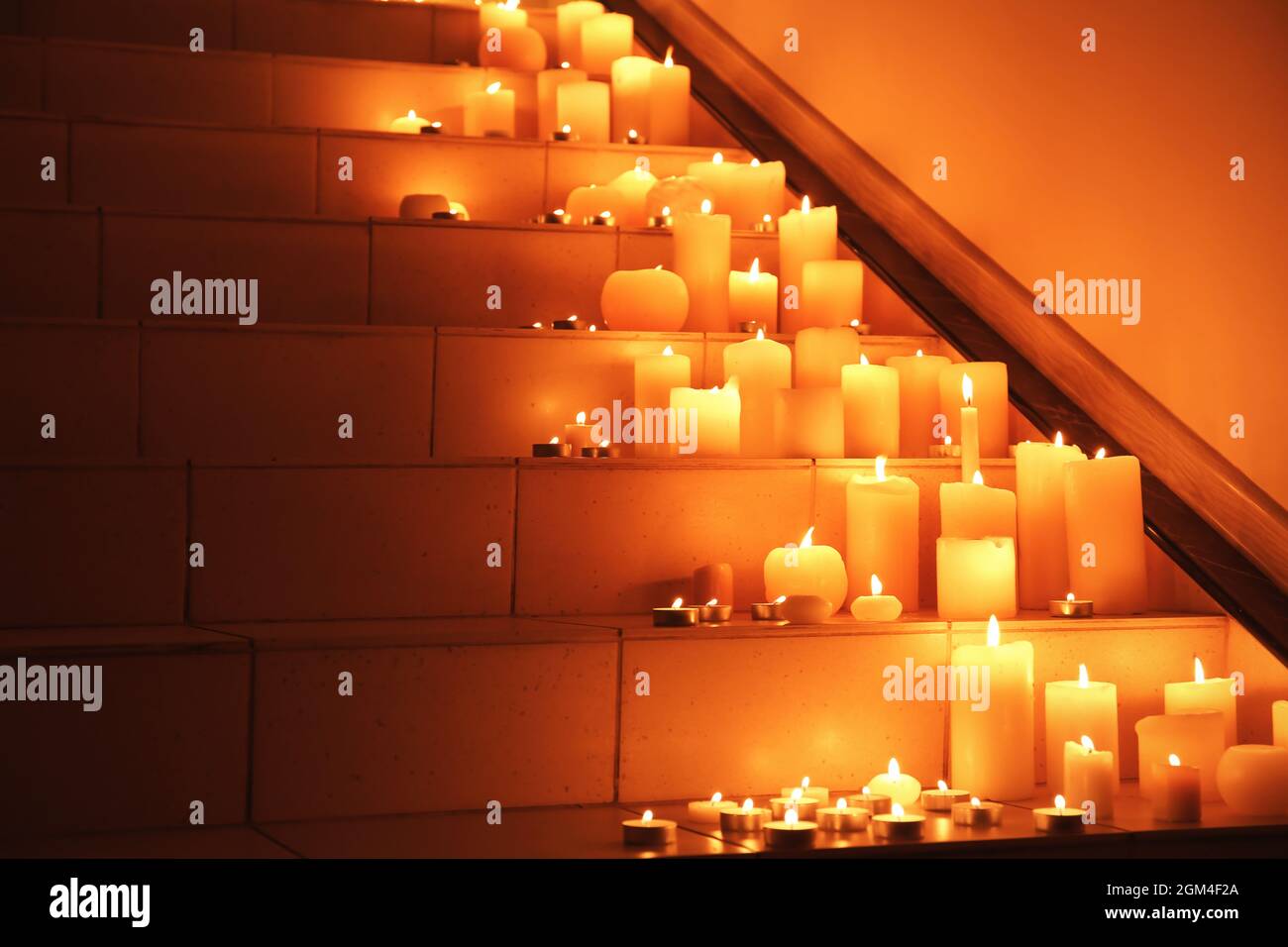 Burning candles on stairs Stock Photo Alamy