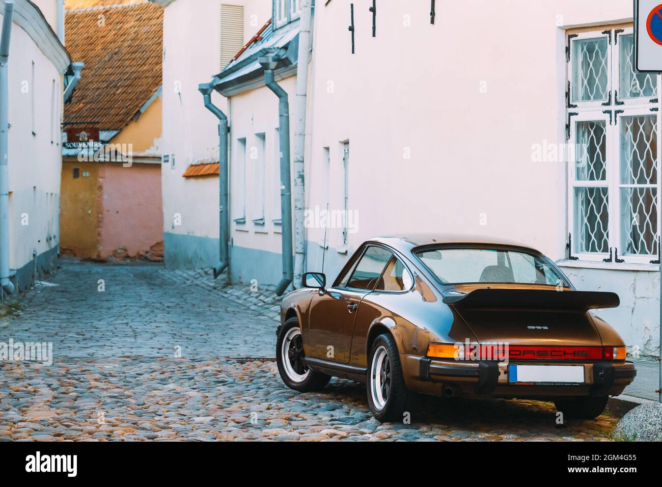 Side View Of Porsche 930 Car Parked In Old Narrow Street. Stock Photo