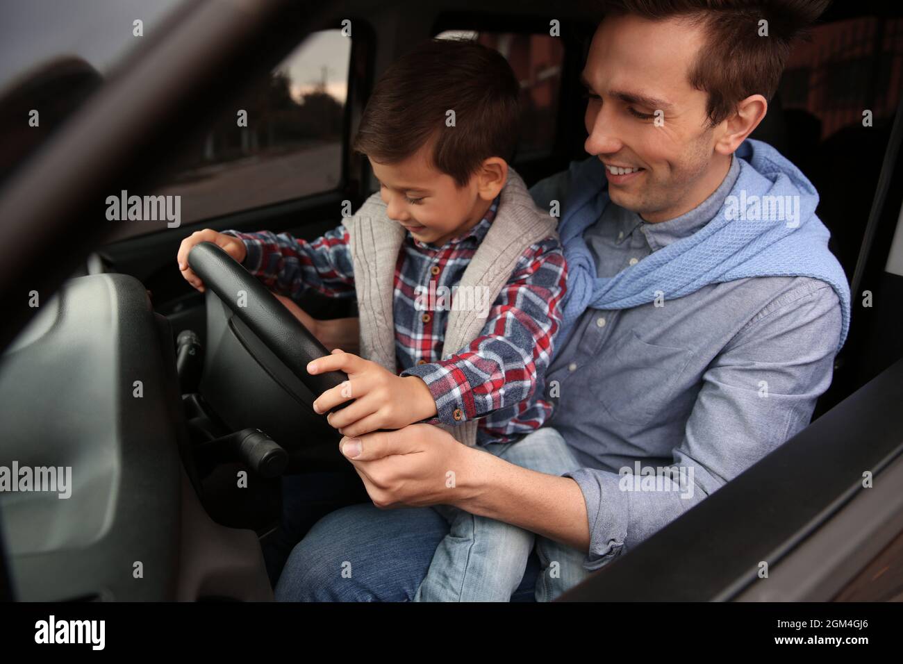 Father teaching his little son to drive a car Stock Photo Alamy