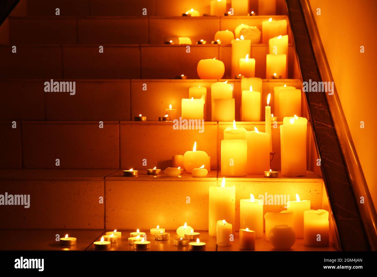 Burning candles on stairs Stock Photo Alamy